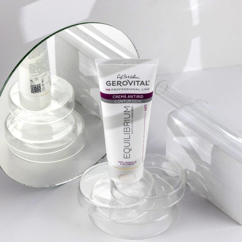 Gerovital Equilibrium Anti-Wrinkle Eye Cream tube on clear dish beside mirror
