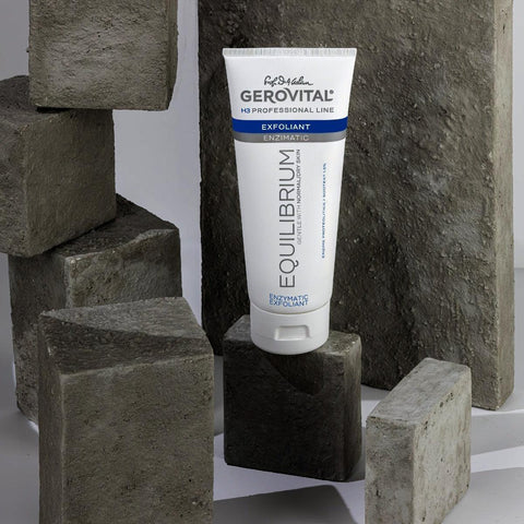 Gerovital Equilibrium Enzymatic Exfoliant tube among rough gray stone blocks