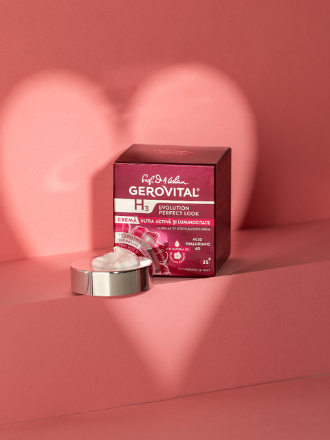 Gerovital Ultra Active Radiance Cream box beside white cream on a silver lid against pink steps