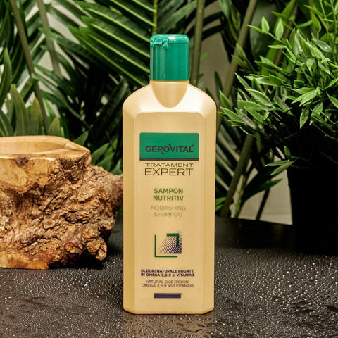 Gerovital Hair Expert Nourishing Shampoo bottle beside wood and green plants