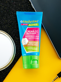 Gerovital Acne Stop Mattifying CC Cream tube beside a phone and mirror on a black and yellow surface
