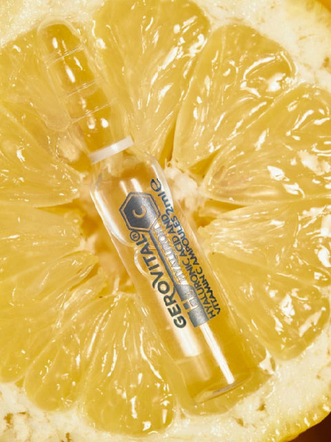 Close-up of a Gerovital H3 Hyaluron C ampoule resting on a lemon slice