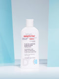 Gerovital H3 Derma+ Face and Eye Cleansing Fluid white bottle against turquoise panels