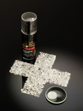 Gerovital Premium moisturising cream bottle beside crystal cross and white cream swatch