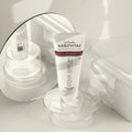 Gerovital Equilibrium Brightening Cream tube on clear dish beside mirror