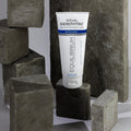 Gerovital Equilibrium Enzymatic Exfoliant tube among rough gray stone blocks