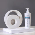 Gerovital Equilibrium Enzymatic Peeling Cream pump bottle beside round white sculptures