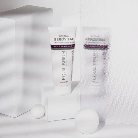 Gerovital Equilibrium Eye Mask tube beside textured glass and white cylinders