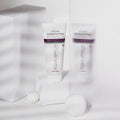 Gerovital Equilibrium Eye Mask tube beside textured glass and white cylinders