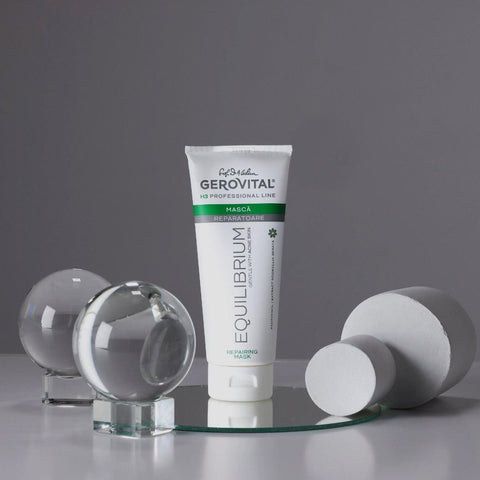 Gerovital Equilibrium Repairing Mask tube on mirror beside clear spheres
