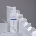 Gerovital H3 Equilibrium Soothing Cleansing Fluid pump bottle beside white geometric blocks and a glass pipette