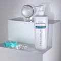 Gerovital Equilibrium Thermo-Active Gel bottle beside clear sphere and glass dishes