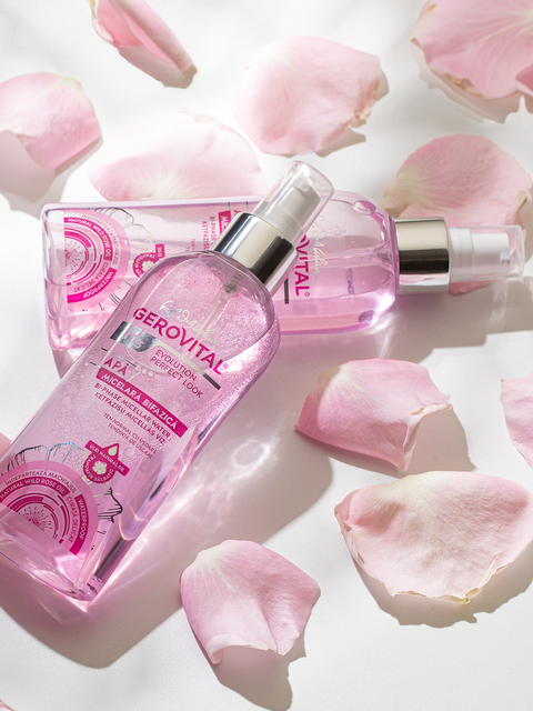 Two pink Gerovital Bi-Phase Micellar Water bottles among pale pink petals