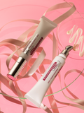 Two Gerovital Eye Contour Firming Cream tubes with ribbon and a cream swatch on a pink surface