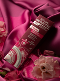 Gerovital Eye Contour Firming Cream box on burgundy fabric beside pink flowers