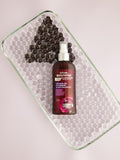 Gerovital H3 Evolution Charcoal and Hyaluronic Acid Micellar Water pump bottle on a glass-bead tray