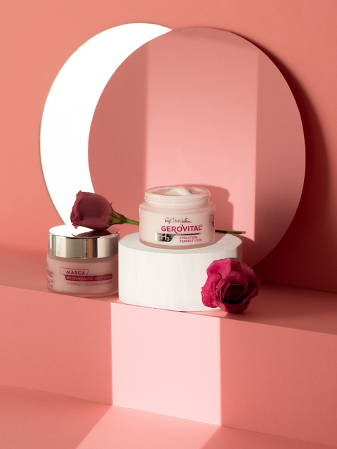 Gerovital Overnight Regenerating Mask jars beside pink roses and a crescent-shaped mirror