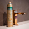 Uncapped Gerovital Conditioning Dry Shampoo can beside a gold-colored faucet