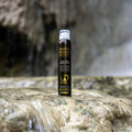 Gerovital Hair Expert Argan Foam Conditioner can on a rock beside running water