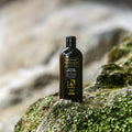 Gerovital Hair Expert Argan Shampoo bottle on a mossy rock
