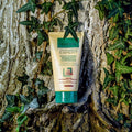 Gerovital Hair Expert Petroleum hair mask tube resting against an ivy-covered tree