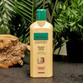 Gerovital Hair Expert Volume Conditioner bottle beside wood and green plants