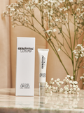 Gerovital Luxury Anti-Dark Circles Gel-Cream tube and box beside flowers