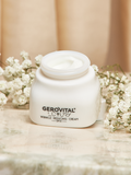 Open Gerovital Luxury Wrinkle-Reducing Cream SPF 15 jar among white flowers