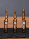 Three Gerovital Men 5% Hyaluronic Acid ampoules standing on black slate