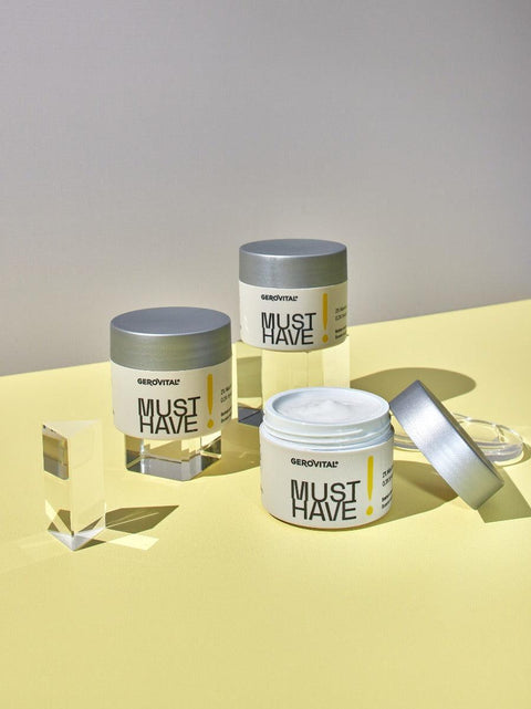 Three Gerovital Must Have sorbet cream jars arranged on clear blocks against yellow