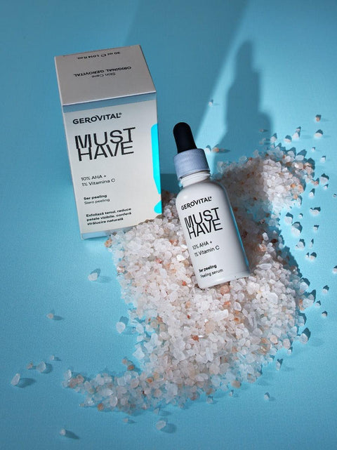 Gerovital Must Have Peeling Serum bottle and box on pale crystals against turquoise
