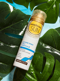 Gerovital Sun 3-in-1 After Sun Spray Lotion can with droplets among wet leaves