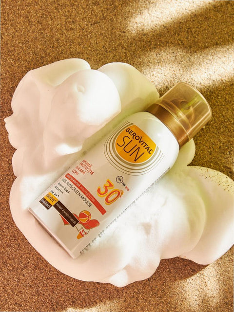 Gerovital Sun Kids Sunscreen Foam SPF 30 can resting in white foam on sand